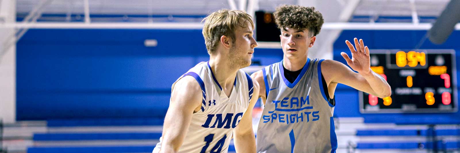 IMG men's basketball player being guarded