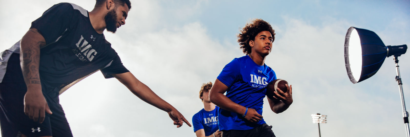 athlete running with a football